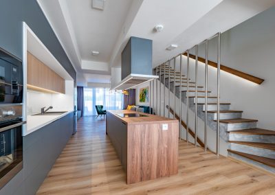 side view of the kitchen and staircase to the first floor